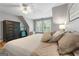 A calm and relaxing bedroom featuring a neutral color palette, a comfortable bed, and natural light at 130 Allie Drive, Mcdonough, GA 30252