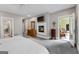 Large main bedroom with fireplace, TV, and door leading to a sunroom at 130 Allie Drive, Mcdonough, GA 30252