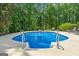 Beautiful backyard pool with diving board and plenty of seating at 130 Allie Drive, Mcdonough, GA 30252