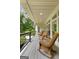 Covered porch with wicker furniture and open views of the lush backyard at 130 Allie Drive, Mcdonough, GA 30252