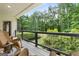 Picturesque backyard views from the covered porch with black railing at 130 Allie Drive, Mcdonough, GA 30252