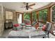 Comfortable screened porch featuring a ceiling fan, wood floors, and wooded views at 130 Allie Drive, Mcdonough, GA 30252