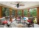 Relaxing screened porch with comfortable seating, ceiling fan, and a view of the sparkling pool and lush greenery at 130 Allie Drive, Mcdonough, GA 30252