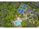 Aerial view of community amenities including a swimming pool and tennis courts surrounded by lush landscaping at 405 Highgrove Dr, Fayetteville, GA 30215