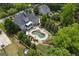 Backyard oasis featuring a sparkling pool, lush landscaping, and outdoor lounging area at 405 Highgrove Dr, Fayetteville, GA 30215