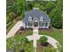 Expansive property featuring lush landscaping, circular driveway, and charming front porch at 405 Highgrove Dr, Fayetteville, GA 30215