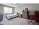 Bedroom featuring carpet floors, neutral paint, and modern furnishings including a computer desk setup at 405 Highgrove Dr, Fayetteville, GA 30215