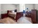 Bedroom with neutral carpet and a queen size bed with wood trim and matching dressers at 405 Highgrove Dr, Fayetteville, GA 30215
