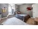 Cozy gray bedroom featuring a unique half-staircase, wall decorations, and plush carpeting at 405 Highgrove Dr, Fayetteville, GA 30215