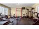 Home gym featuring black rubber flooring, various exercise machines, and natural light from the window at 405 Highgrove Dr, Fayetteville, GA 30215