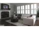Cozy living room with a stone fireplace, large windows, and a plush sectional sofa at 405 Highgrove Dr, Fayetteville, GA 30215