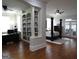 Open concept main bedroom featuring hardwood floors, a canopy bed, a bookshelf, and access to the exterior at 405 Highgrove Dr, Fayetteville, GA 30215