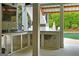 View of outdoor kitchen with stainless steel cabinets and a built-in sink overlooking the pool at 405 Highgrove Dr, Fayetteville, GA 30215