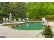A backyard pool area surrounded by green grass and a variety of seating, perfect for relaxation at 405 Highgrove Dr, Fayetteville, GA 30215