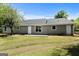 View of the backyard and rear of a single-story home, with gray siding and white trim at 1404 Meadowind Court Sw, Conyers, GA 30094