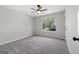 Bright bedroom featuring a ceiling fan, carpet, and a large window at 1404 Meadowind Court Sw, Conyers, GA 30094