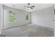 Spacious bedroom featuring two bright windows and a ceiling fan at 1404 Meadowind Court Sw, Conyers, GA 30094