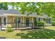 Charming home featuring stone accents, black shutters and a blue door at 1404 Meadowind Court Sw, Conyers, GA 30094