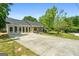 Charming single-story home with large driveway, stone facade and ample natural light at 1404 Meadowind Court Sw, Conyers, GA 30094