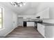 Well-lit kitchen with white cabinets, subway tile backsplash, granite countertops, and stainless steel appliances for cooking at 1404 Meadowind Court Sw, Conyers, GA 30094