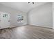 Bright and airy living room featuring wood-look floors, and neutral paint, complete with a white door and a large window at 1404 Meadowind Court Sw, Conyers, GA 30094