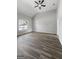 Large, bright living room with wood floors and neutral colors, offering a clean look and a ceiling fan for comfort at 1404 Meadowind Court Sw, Conyers, GA 30094