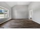 Spacious living room with new wood floors, neutral paint, and lots of natural light from a large window offers an open space at 1404 Meadowind Court Sw, Conyers, GA 30094
