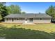 Spacious backyard featuring a well-maintained lawn and the rear exterior of the home at 1425 Meadowind Court Sw, Conyers, GA 30094