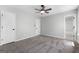 Spacious carpeted bedroom with ensuite bathroom, ceiling fan, and natural light at 1425 Meadowind Court Sw, Conyers, GA 30094