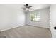 Cozy bedroom with soft carpet, ceiling fan, and a window with outdoor views at 1425 Meadowind Court Sw, Conyers, GA 30094