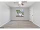 Bright bedroom featuring soft carpet, a window, ceiling fan, and neutral walls at 1425 Meadowind Court Sw, Conyers, GA 30094