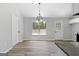 Bright dining room featuring vinyl flooring, and a modern light fixture at 1425 Meadowind Court Sw, Conyers, GA 30094