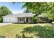 Charming single-story home with manicured lawn, two-car garage, and a welcoming front porch at 1425 Meadowind Court Sw, Conyers, GA 30094
