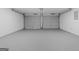 Spacious two-car garage with painted walls and concrete floor at 1425 Meadowind Court Sw, Conyers, GA 30094
