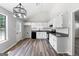 Bright kitchen featuring white cabinets, granite countertops, and stainless steel appliances at 1425 Meadowind Court Sw, Conyers, GA 30094