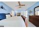 Bedroom with blue walls, carpet, wooden furniture, and a bed with white linens and blue pillows at 212 Warrenton Dr, Douglasville, GA 30134