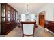 Formal dining room with a large table, seating for six, and elegant built-in storage at 212 Warrenton Dr, Douglasville, GA 30134