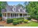 Charming two-story home with a welcoming front porch and well-manicured landscaping at 212 Warrenton Dr, Douglasville, GA 30134