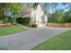 Side view of home showcasing a driveway that leads to a three-car garage at 212 Warrenton Dr, Douglasville, GA 30134
