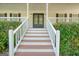 Welcoming front porch with elegant double doors and meticulously maintained shrubs at 212 Warrenton Dr, Douglasville, GA 30134
