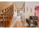 Hallway with hardwood floors, staircase, and view of the living room at 212 Warrenton Dr, Douglasville, GA 30134