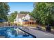 Beautiful backyard with a large in-ground pool, spacious deck and patio perfect for outdoor entertaining at 212 Warrenton Dr, Douglasville, GA 30134