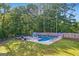 This pool features a fence, lounge chairs, and umbrellas at 212 Warrenton Dr, Douglasville, GA 30134