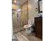 Bathroom featuring a modern tiled shower with glass door, toilet and wooden vanity with sink at 1055 Worthington Hills Dr, Roswell, GA 30076
