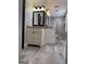 Bathroom features wood plank flooring, double vanity, and updated shower at 1055 Worthington Hills Dr, Roswell, GA 30076