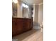 Bathroom featuring double vanity, tiled floors, and shelves for storage at 1055 Worthington Hills Dr, Roswell, GA 30076