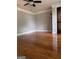 Bright bedroom featuring hardwood floors, neutral paint, and a wood-stained door at 1055 Worthington Hills Dr, Roswell, GA 30076