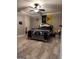 A neutral toned main bedroom boasts a ceiling fan, wood-look floors, and a flag wall decor at 1055 Worthington Hills Dr, Roswell, GA 30076