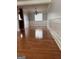 Empty dining room boasts hardwood floors, paneled walls, chandelier, and abundant natural light at 1055 Worthington Hills Dr, Roswell, GA 30076