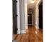 Inviting hallway featuring gleaming hardwood floors, neutral walls, and modern lighting at 1055 Worthington Hills Dr, Roswell, GA 30076